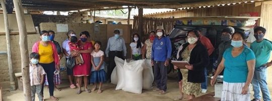 rural community in masks receive grains