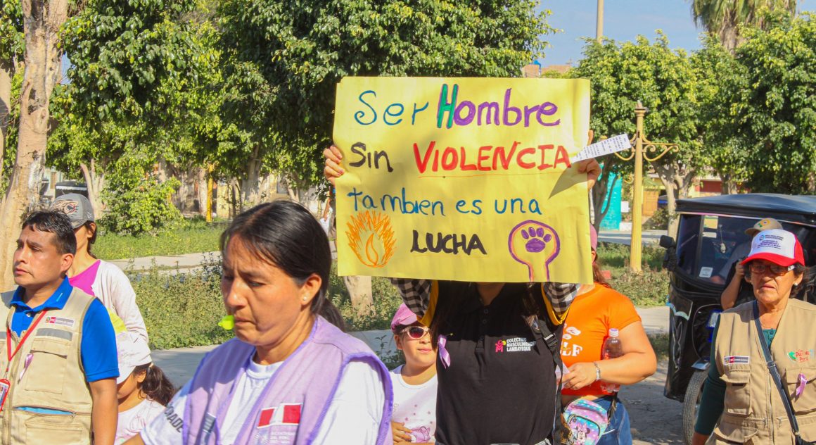 program participants join in the march on International Women's Day with signs calling for an end to gender-based violence