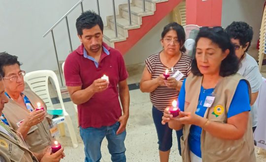 a group of six men and women hold candles
