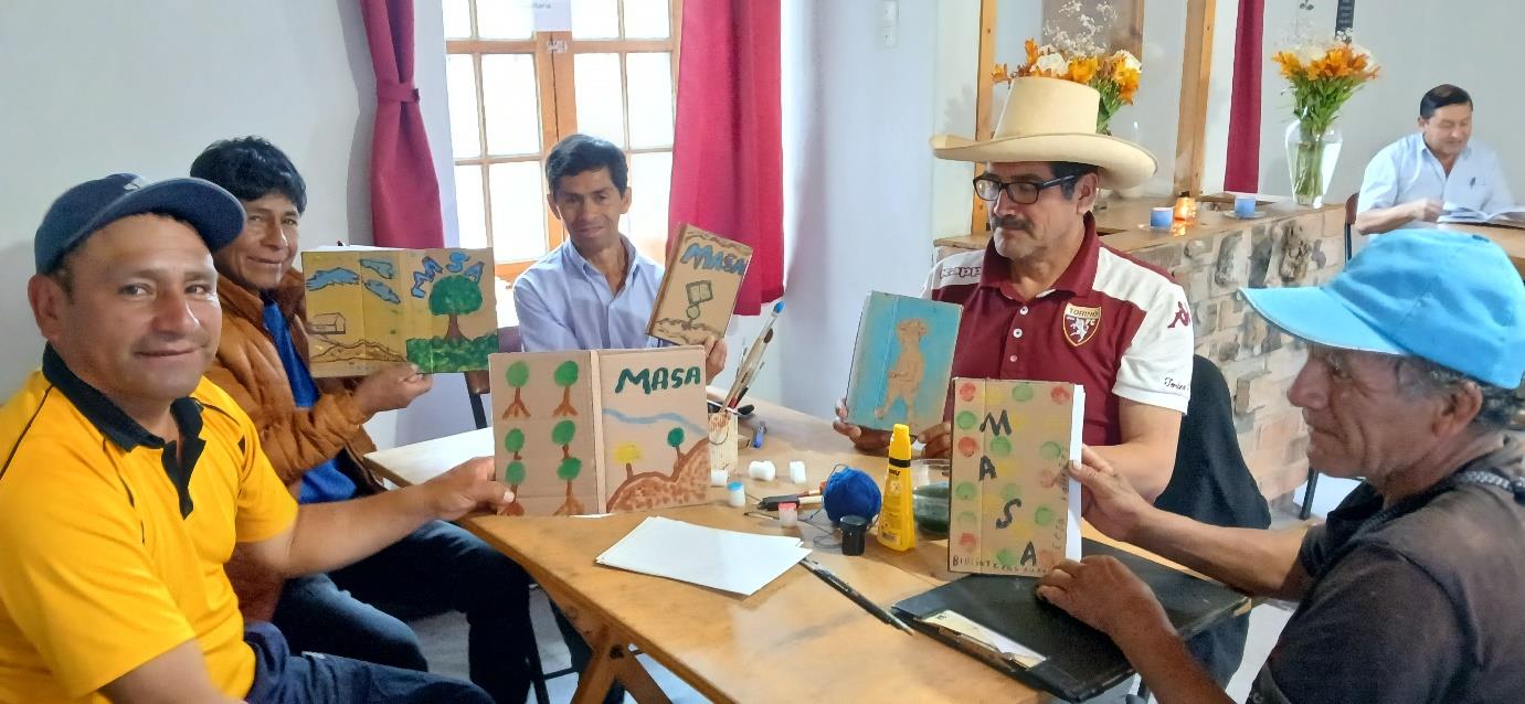 Rural librarians seated at a table show their new books