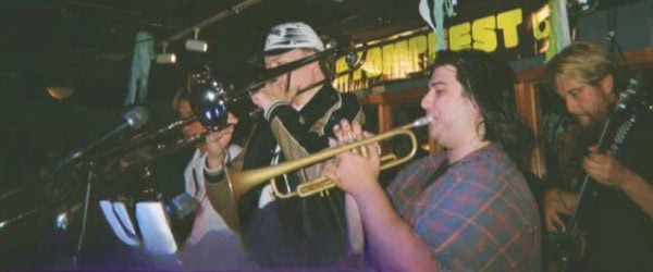 los freakies with trumpet, trombone and guitar players visible