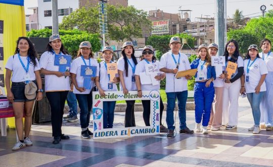 Young leaders stand in a row holding a sign that calls for active citizenship