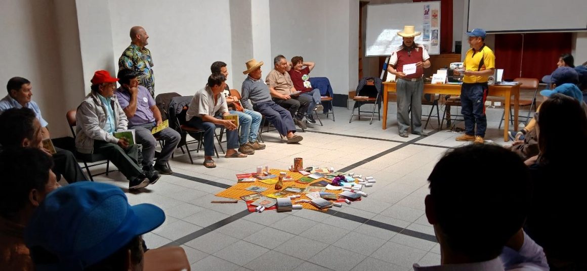 Rural librarian sit in a circle around a central display of books